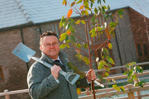 Job done, Jeff Guest with one of the planted trees.